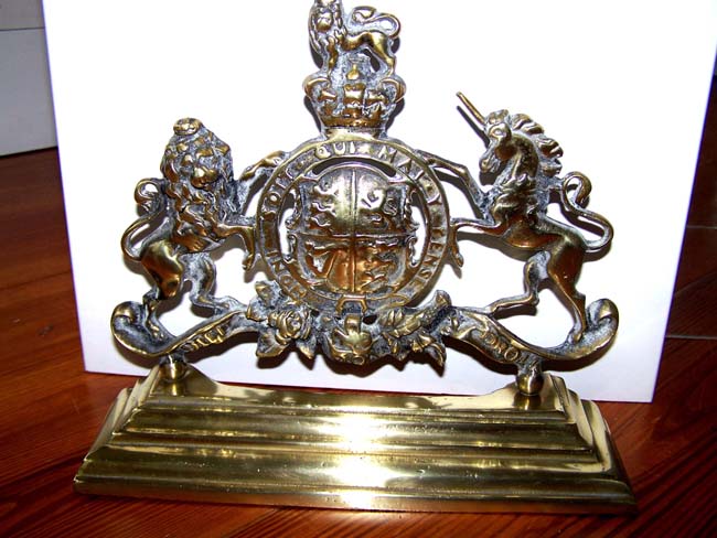 A charming late 19th century English Brass Door Stop having the Royal Coat-of-Arms